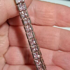 Silver color and pink stone tennis style bracelet very bright and shiny looking